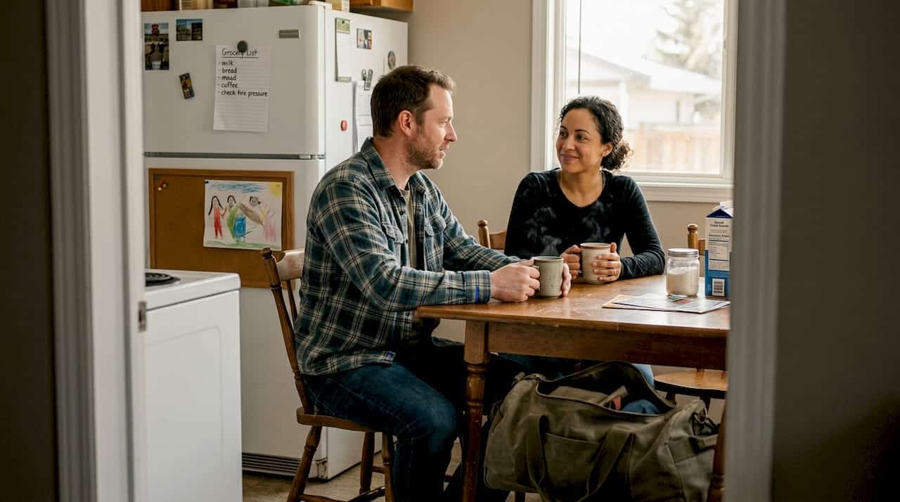 Camp worker talking with partner at home
