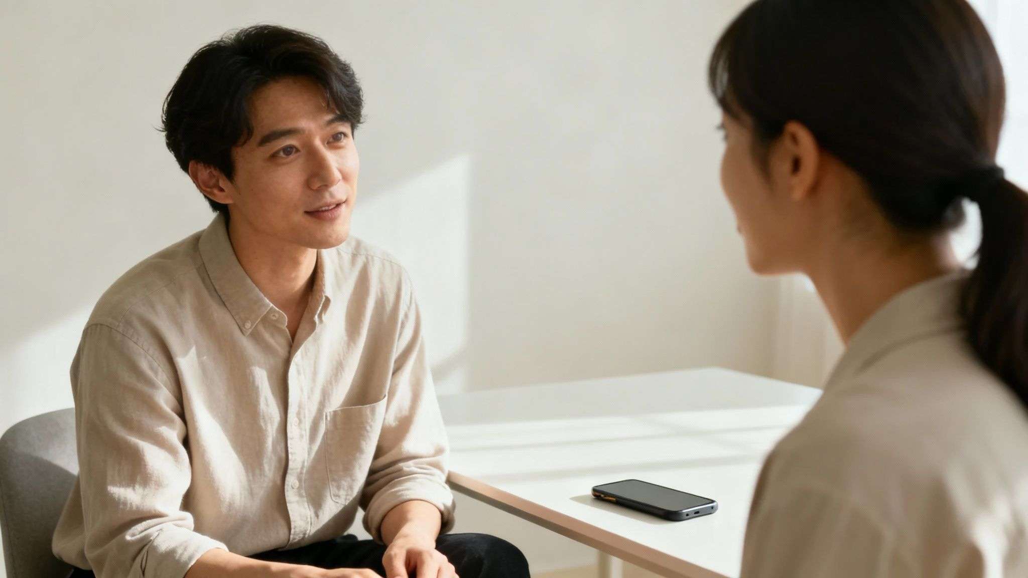 A couple sitting on a couch, focused on listening to each other with empathy.