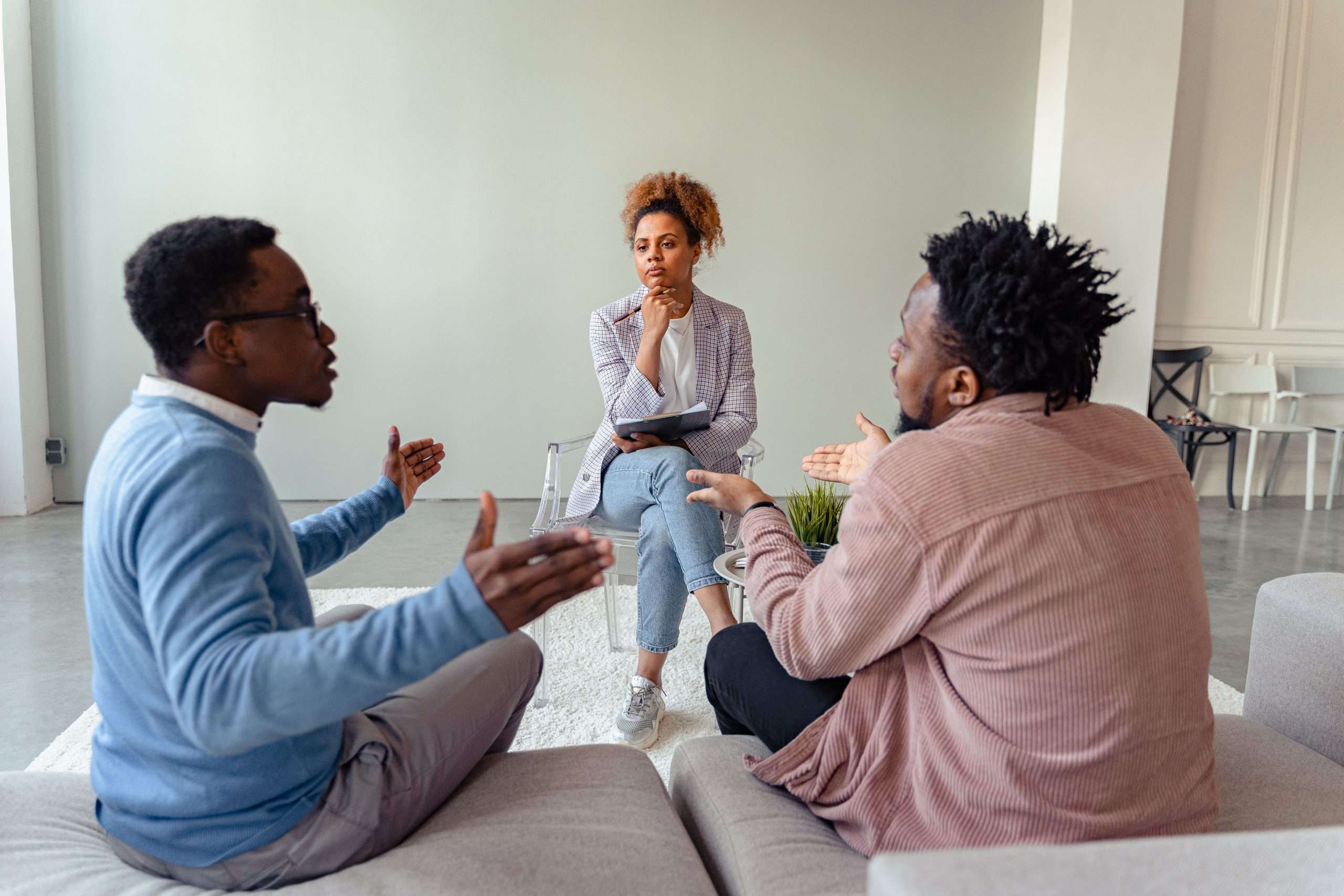 couples therapy exercises for emotional intimacy - A therapy session featuring a diverse group discussing issues with a mental health professional.