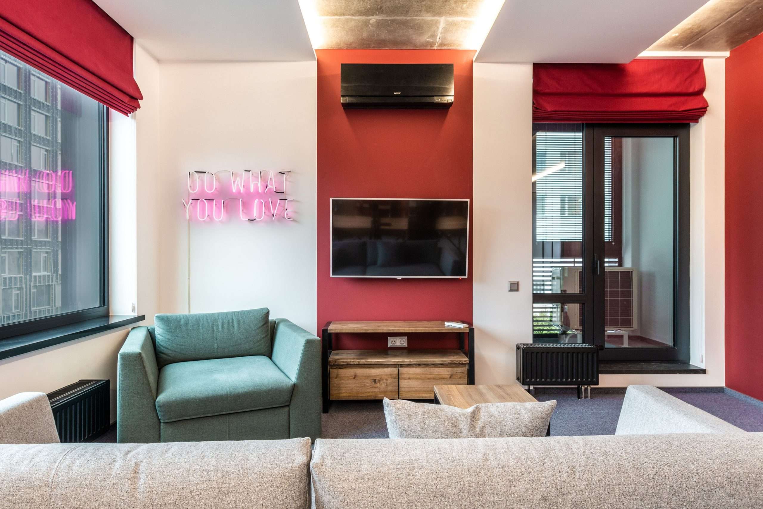 what are the 7 love languages - Interior of modern office lounge zone with sofa and armchair with table near window next to TV on wall and neon signboard with text do what you love near door